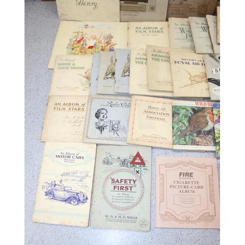 529 - Large quantity of cigarette cards mainly in albums plus a number of related reference books