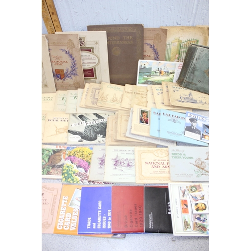 529 - Large quantity of cigarette cards mainly in albums plus a number of related reference books