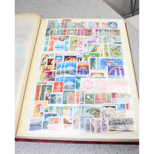 532 - 2 stamp stock books containing mainly foreign stamps & a Liberty stamp album with contents