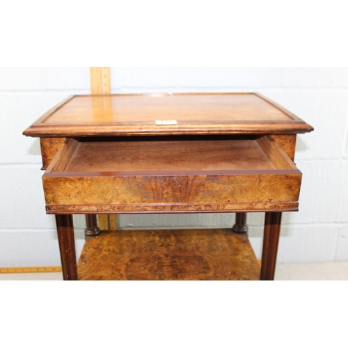 127 - A Victorian walnut two tier stand or side table with integrated drawer on turned column supports wit... 