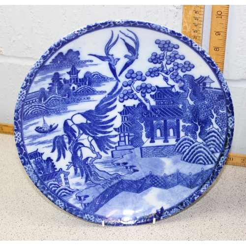 1812 - 2 large Oriental blue and white chargers depicting traditional scenes/designs, approx 30cm diameter ... 