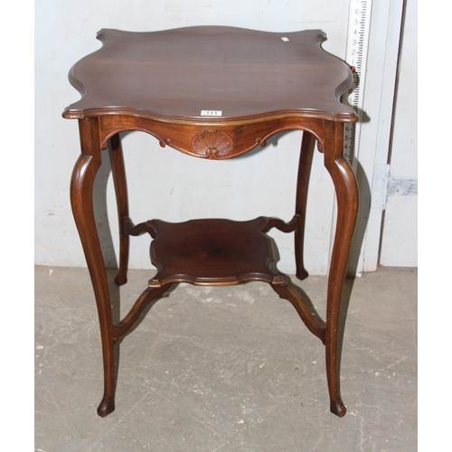 111 - Mahogany occasional table of unusual form with carved detail to the frame