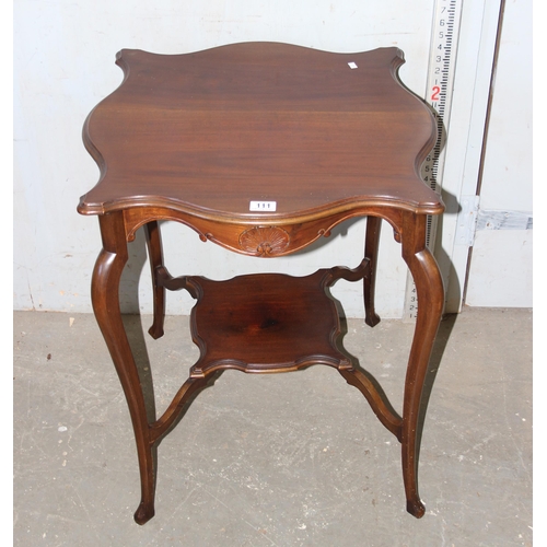 111 - Mahogany occasional table of unusual form with carved detail to the frame