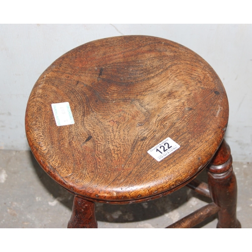 122 - An antique rustic elm stool with tripod base