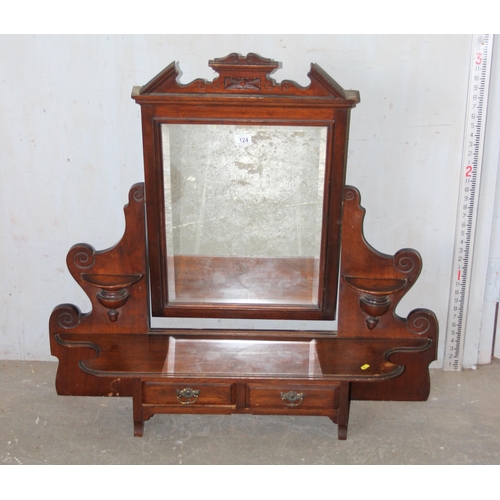 124 - An antique mahogany over mantle mirror with candle sconces