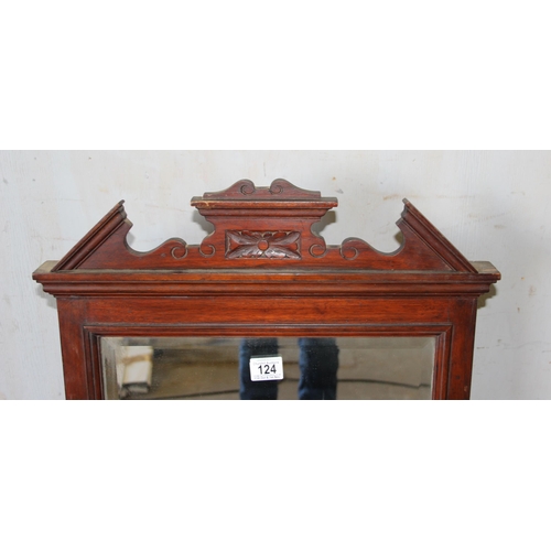 124 - An antique mahogany over mantle mirror with candle sconces