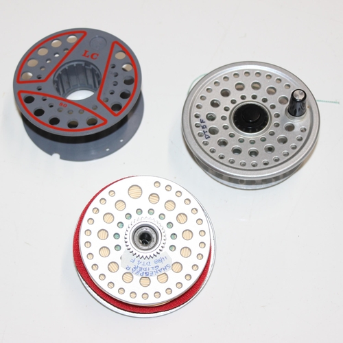 715 - 4 fly fishing reels in carry case along with spare spools and reel cases. Reels include Shakespear S... 