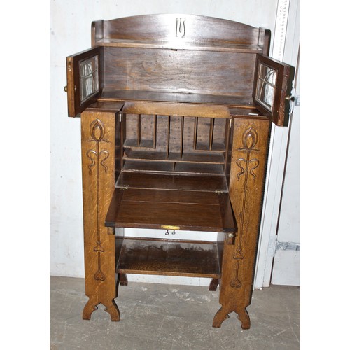 68 - An unusual Art Nouveau oak folding desk with glazed bookcase cabinet to top, bookcase sides and carv... 