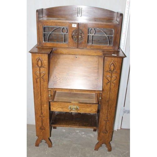 68 - An unusual Art Nouveau oak folding desk with glazed bookcase cabinet to top, bookcase sides and carv... 