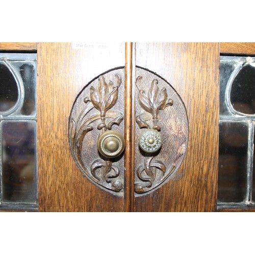 68 - An unusual Art Nouveau oak folding desk with glazed bookcase cabinet to top, bookcase sides and carv... 