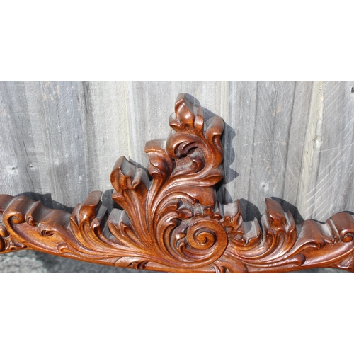 499j - A vintage mahogany wall mirror of unusual form and carved details