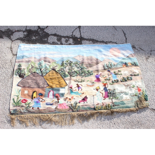 213 - Extremely large African hand woven tapestry showing a village scene, approx 250cm x 145cm. Produced ... 