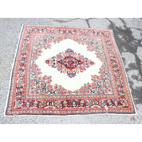 216 - A good quality vintage cream ground rug with central medallion and arabesque border, approx 130cm