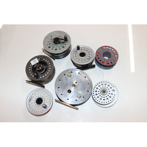 715 - 4 fly fishing reels in carry case along with spare spools and reel cases. Reels include Shakespear S... 