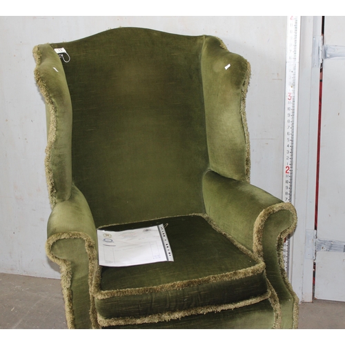 13 - A vintage green upholstered wingback armchair, Georgian style