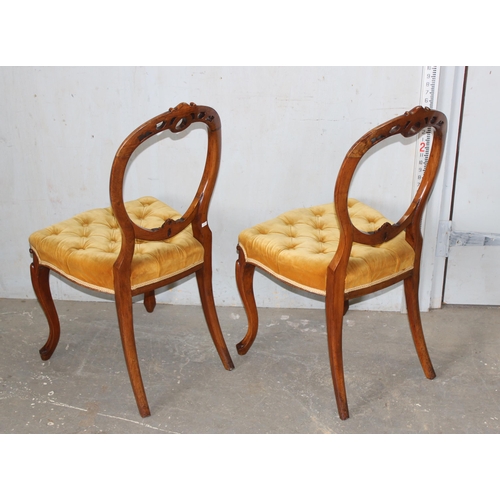 14 - A pair of Victorian balloon backed bedroom chairs with stuffed seats with buttoned gold coloured uph... 