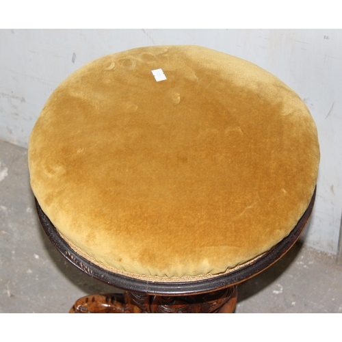 18 - A 19th century adjustable topped piano stool with gold coloured upholstery and carved details