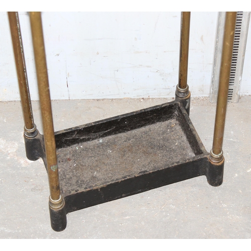 19 - An early 20th century cast iron and brass umbrella or stick stand