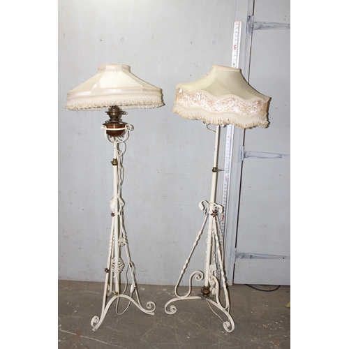 231 - A pair of antique white painted wrought iron oil lamps later converted into standard lamps with shad... 