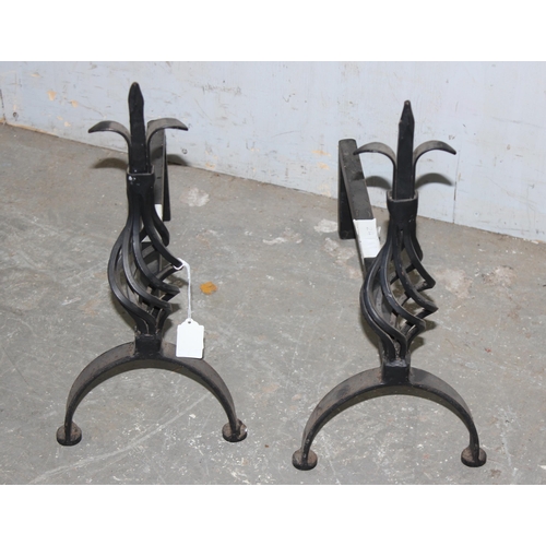 94 - Pair of cast iron firedogs with twisted Fleur de Lis design