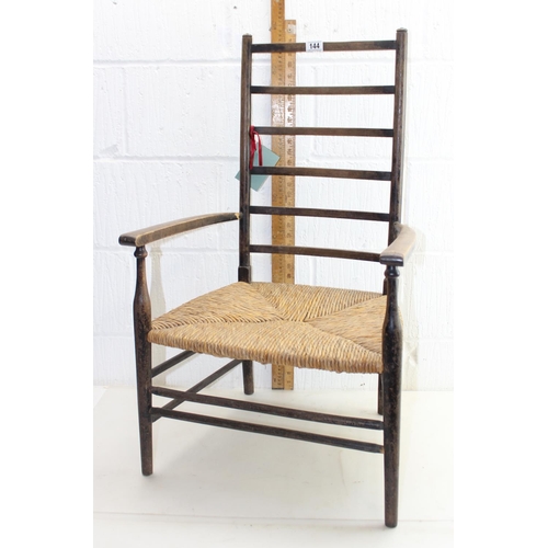 178 - An Arts & Crafts period rush seated ladder back armchair, strongly in the manner of Liberty & Co, St... 