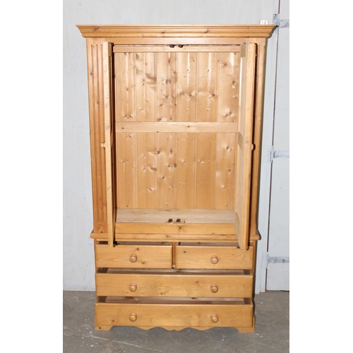 132 - A vintage pine wardrobe with 2 over 2 chest of draw base