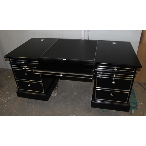 137 - An extremely impressive large black and silver gilt desk, with leather top insert.