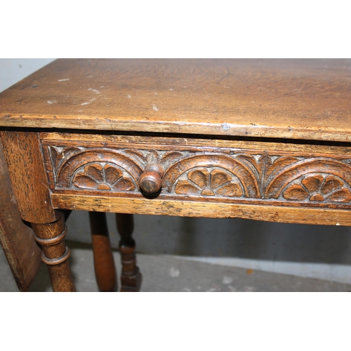 145 - Highly carved Jacobean style oak drop leaf table