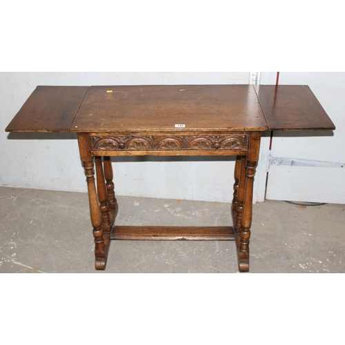 145 - Highly carved Jacobean style oak drop leaf table