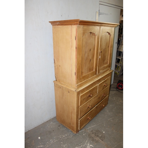 166 - A Victorian pine linen press type cupboard with a 2 doored cupboard standing on a 2 over 2 chest of ... 