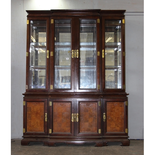 82 - A large antique style 4 door display cabinet with mirrored back and interesting brass furniture