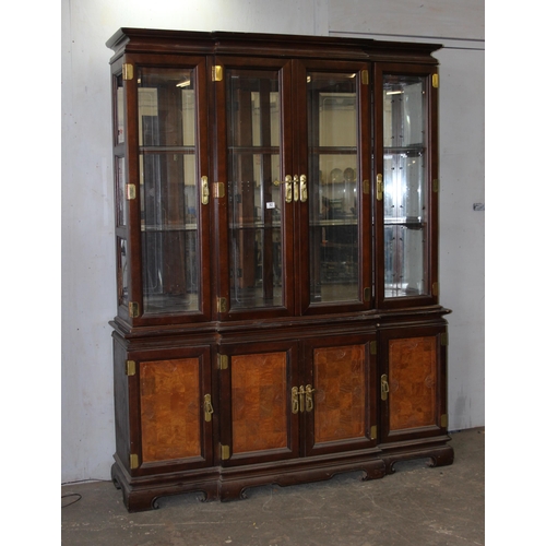 82 - A large antique style 4 door display cabinet with mirrored back and interesting brass furniture