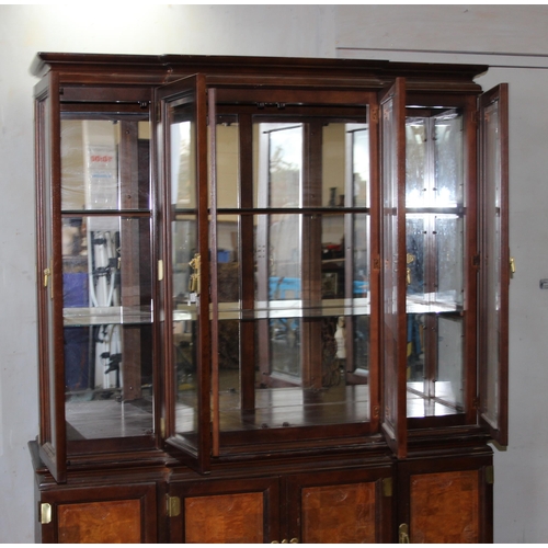 82 - A large antique style 4 door display cabinet with mirrored back and interesting brass furniture