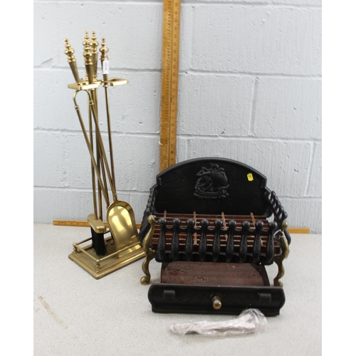 100A - Cast iron fire basket and a set of brass fire irons