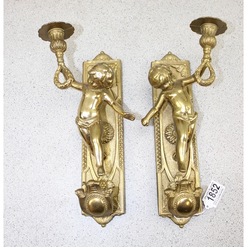 1852 - A pair of classical style brass wall sconces designed as cherubs holding a torch