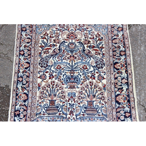 212 - Hand tied blue and cream ground rug with floral border