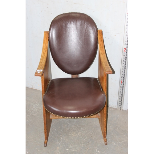 21 - An unusual Art Deco style oak chair with studded red leather seat