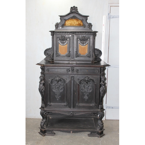 24 - A 19th century Continental ebonised and profusely carved 2 tier buffet cabinet in the German Renaiss... 