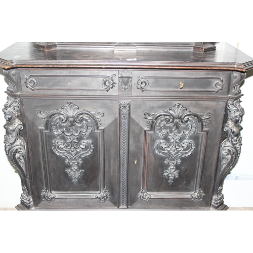 24 - A 19th century Continental ebonised and profusely carved 2 tier buffet cabinet in the German Renaiss... 