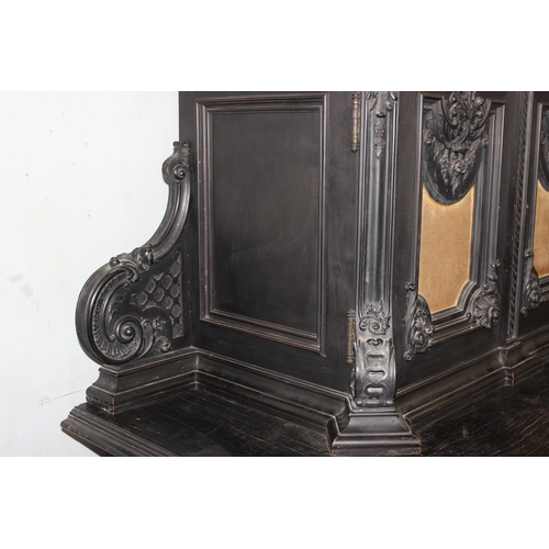 24 - A 19th century Continental ebonised and profusely carved 2 tier buffet cabinet in the German Renaiss... 