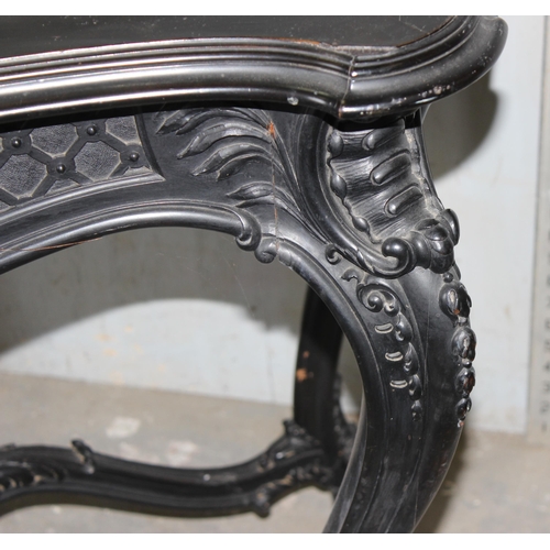 25 - A 19th century Continental ebonised and profusely carved side table with green fabric top in the Ger... 