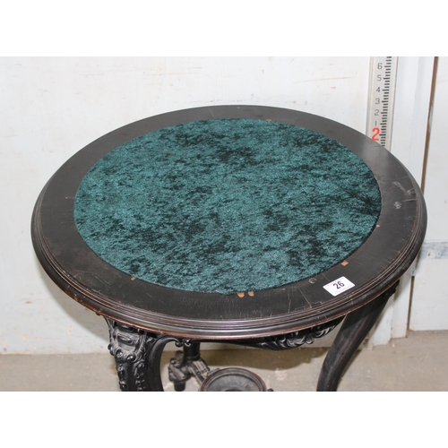 26 - A 19th century Continental ebonised and profusely carved round topped table with green fabric top in... 