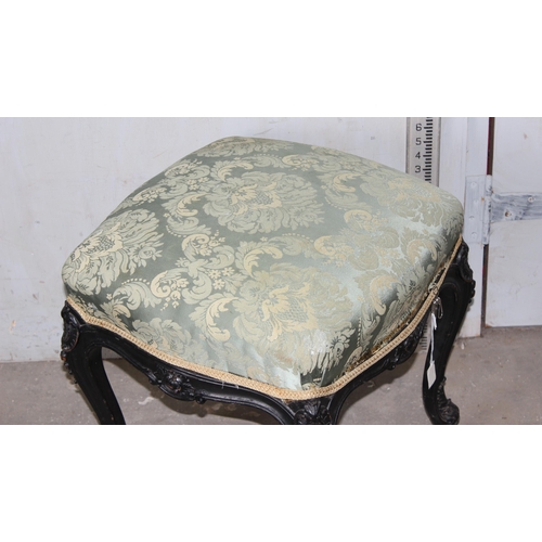 27 - A 19th century Continental ebonised and profusely carved stool with stuffed green fabric top in the ... 