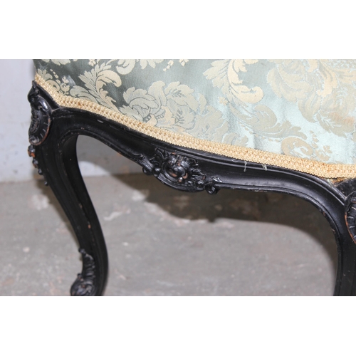 27 - A 19th century Continental ebonised and profusely carved stool with stuffed green fabric top in the ... 