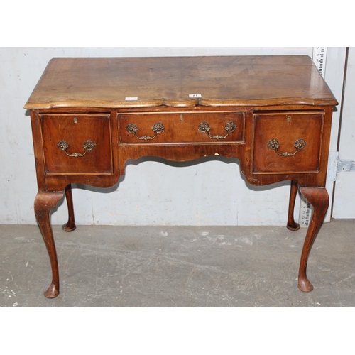 65 - An 18th century style lowboy with brass drop handles and cabriole legs by Kerridges of Hailsham, app... 