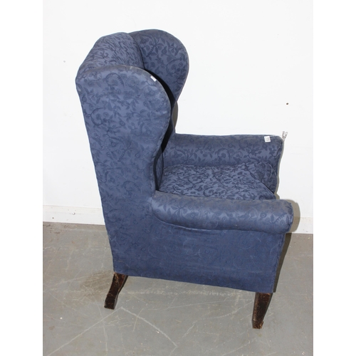 113 - A vintage wingback armchair with blue upholstery