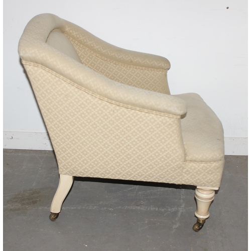 32 - A Victorian tub chair with cream patterned upholstery and painted turned legs