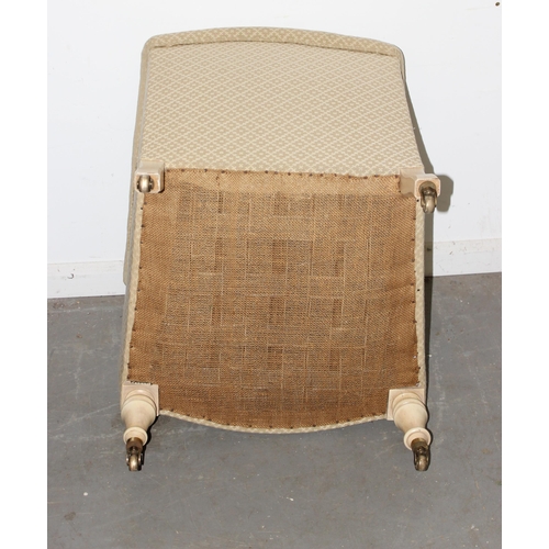 32 - A Victorian tub chair with cream patterned upholstery and painted turned legs