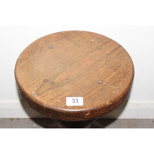 33 - A small vintage rustic oak stool