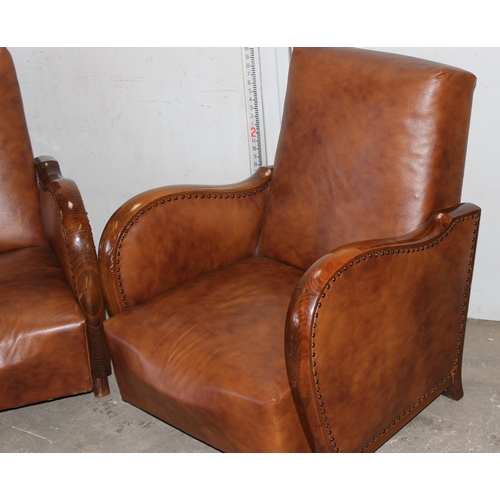 1 - A pair of Art Deco style light brown faux leather and wooden framed library or club chairs with stud... 